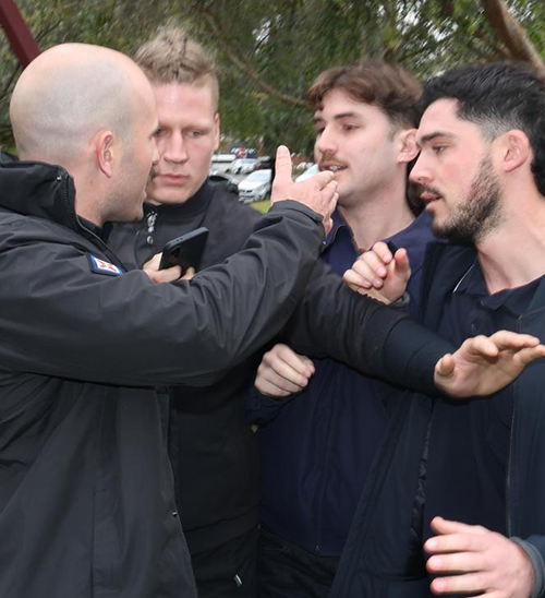 Breaking News: Black-Clad Man Disrupts Press Conference, Premier Escapes, Thousands Demand Deportati